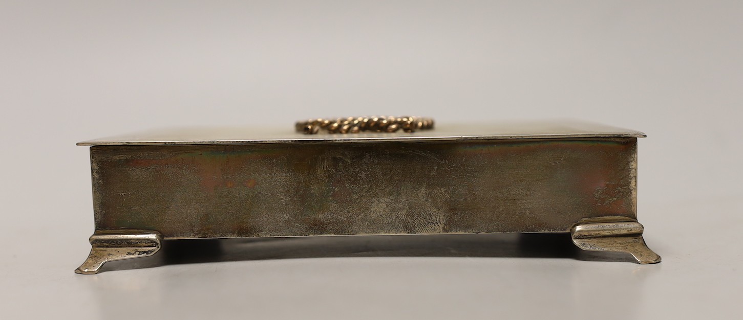 An Elizabeth II engine turned silver rectangular cigarette box, with yellow metal applique and interior inscription relating to the Hong Kong Rope Manufacturing Co, 17.4cm.